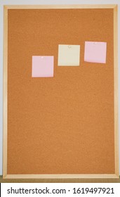 Pink And Yellow Sticky On Corkboard
