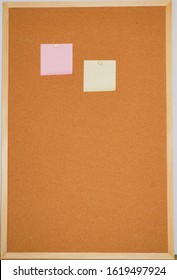 Pink And Yellow Sticky On Corkboard
