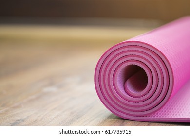 Pink Yoga Mat On Wood Table