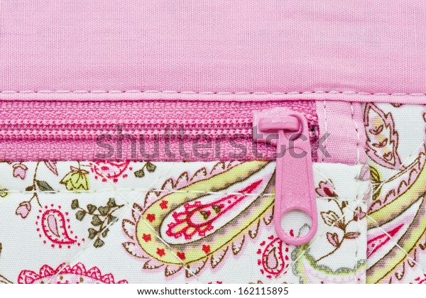  pink zip on a bag\
background