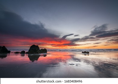 Pinky Clouds Before Sunrise On The Beach In  Sumner, Christchurch, NZ