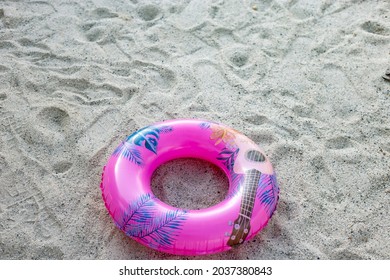 A Pinky Rubber Ring On The White Beach.