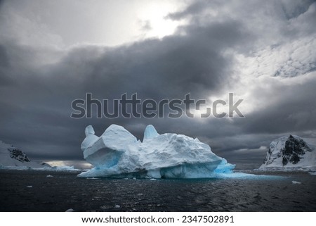 Pinnacle berg closeup; Antarctic Peninsula; Pinnacle berg; Antarctic Peninsula; Turquoise grotto, at sea level; South Shetland Islands; Two sea level grottos, around the back; South Shetland, Islands
