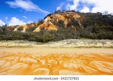 The Pinnacles are coloured sands cliffs located along the 75 mile beach on the east coast of Fraser Island, Queensland, Australia - They have been stained over thousands of years with clay - Powered by Shutterstock