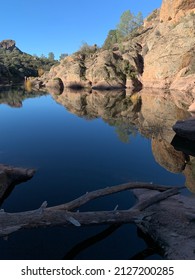 Pinnacles National Park Monterey California or National Monument Red rocks over looking a reservoir with beautiful perfect seamless reflections great place to get out and go for a hike and adventure