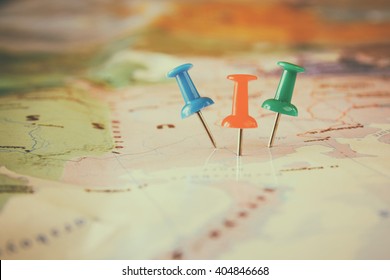 pins attached to map, showing location or travel  destination . retro style image. selective focus. - Shutterstock ID 404846668