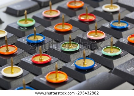 Pins on computer keyboard - concept background