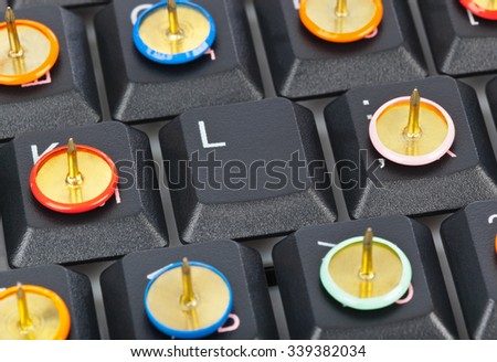 Pins on computer keyboard - concept background