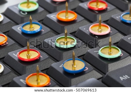 Pins on computer keyboard - concept background