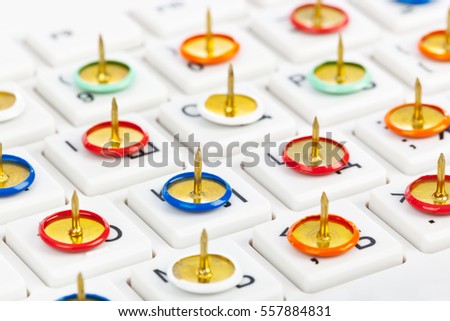 Pins on computer keyboard - concept background