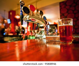 Pint Of Beer On A Bar In A Traditional Style English Pub