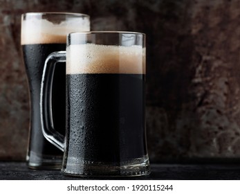 Pint Glass Mug Of Dark Cold Craft Beer On An Iron Background Close Up