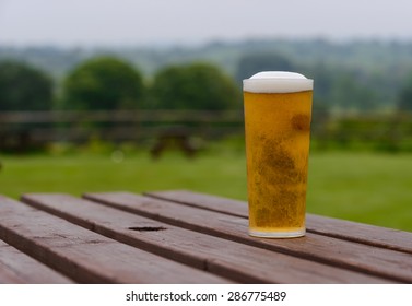 Pint Of Lager Beer On Country Pub Beer Garden Table