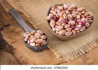 Pinto beans on wood bowl