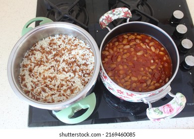 Pinto or kidney beans and rice pilaf in pot on the stove. Close up and top view on cooked pinto beans known as in Turkey ‘barbunya pilaki’ and rice pilaf.