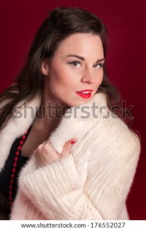 Pinup Girl in Creamy Fur Coat - red background