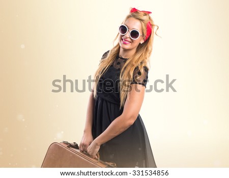 Pin-up girl holding a suitcase