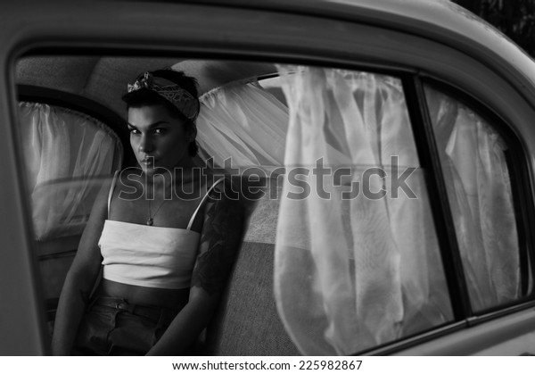 pin-up lady with tattoos
in retro car