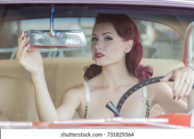 A Pinup Model Posing With A 1950s Car