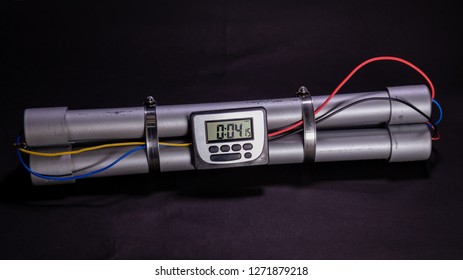 Pipe bomb with an lcd clock timer to trigger detonation on black background