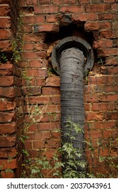 Pipe extending from brick wall