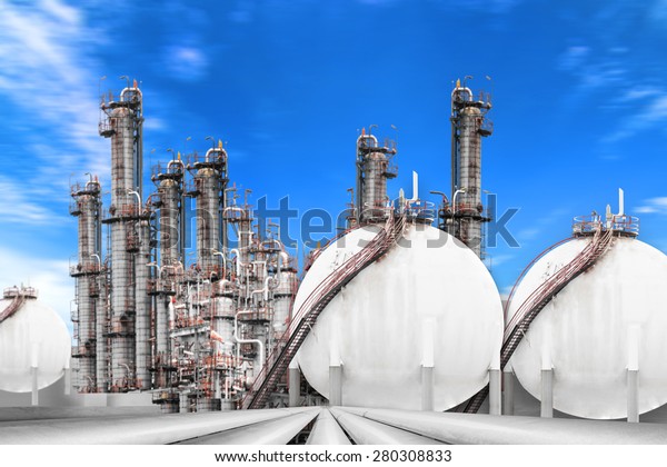 pipe line connection to oil tanks in\
petrochemical oil refinery against blue\
sky