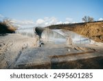 Сonstruction of a pipe on the river bottom under road