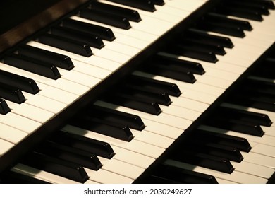 Pipe organ keyboards close-up view, selective focus. Old organ keys