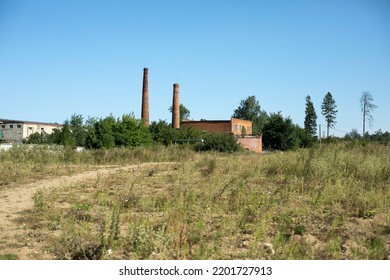 Pipe Plant. Brick Factory In Countryside. Industrial Zone Outside City. Old Building On Sunny Day.