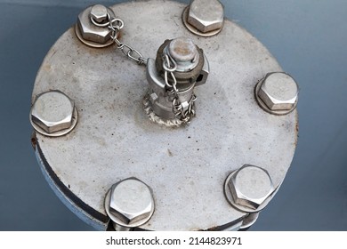 Pipe section with flange and welded adapter with stainless steel chain and screwed bolts. Ship flange for receiving or dispensing water or fuel.