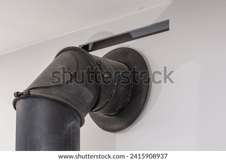 A pipe that discharges smoke from the fireplace to the ventilation system in the chimney