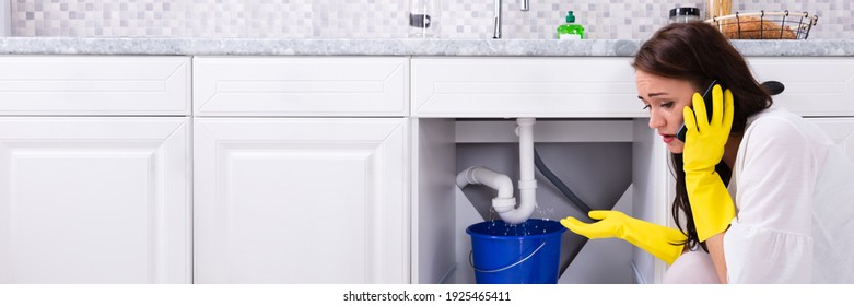 Pipe Water Leak In Kitchen Sink. Calling Plumber