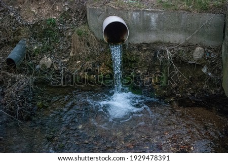 a pipe from which water flows into a stream