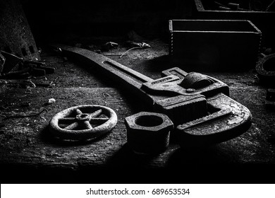 Pipe wrench and parts at an abandoned silk mill.