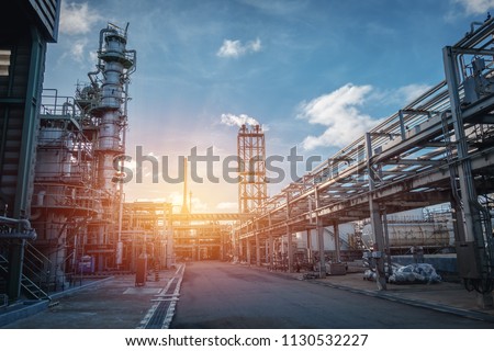 Pipeline and pipe rack of petroleum industrial plant with sunset sky background