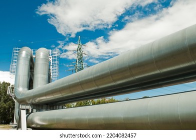 Pipeline And Power Lines On The Background Of Blue Sky And Clouds.