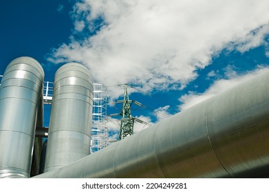 Pipeline And Power Lines On The Background Of Blue Sky And Clouds.