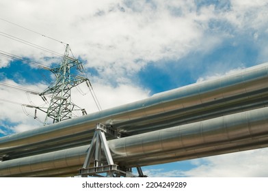 Pipeline And Power Lines On The Background Of Blue Sky And Clouds.