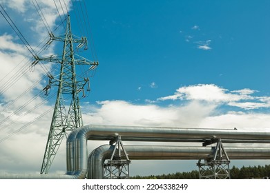 Pipeline And Power Lines On The Background Of Blue Sky And Clouds.