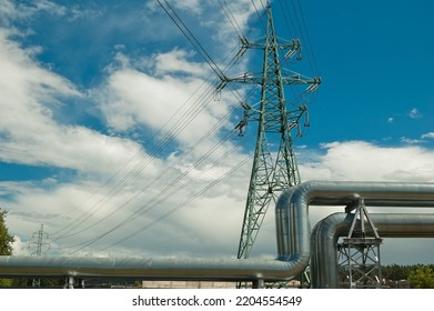 Pipeline And Power Lines On The Background Of Blue Sky And Clouds.