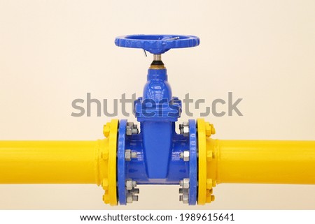 Pipeline with valve. Yellow tube with blue crane, oil and gas industry