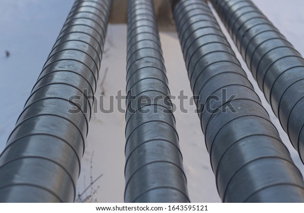 Pipes with\
hot and cold water. City communications. Metal pipes above the\
ground. Element of the water supply\
system.