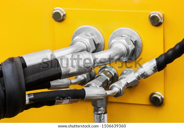 pipes and the\
hydraulic system of the tractor or excavator.Focus on the left side\
of the frame on the pipes