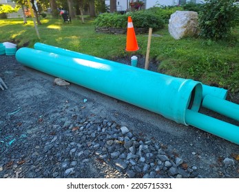 Pipes And Orange Cones Along A Roadside Being Used For Replacing Water Pipes.