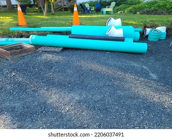 Pipes And Orange Cones Along A Roadside Being Used For Replacing Water Pipes.