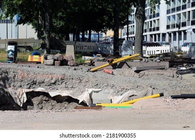 Pipes, Waterline Pieces, Fences And Other Construction Materials On The Ground In A Construction Site In Helsinki, Finland, June 2019. Sunny Summer Day Image. Plumbing And Sewage Repair Materials.