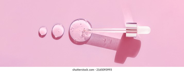 Pipette Drop Of Serum Test On A Pink Background	
