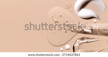 pipette drop of serum test, samples of cosmetic care products smears of cream gel texture on a beige background