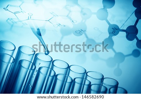 A pipette dropping sample into a test tube,abstract science background