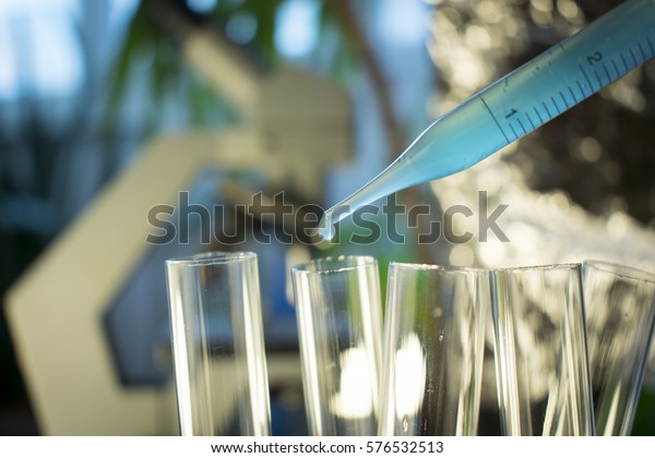 Pipette with fluid and test tubes\
for cancer immunotherapy research cancer study and gene therapy\
